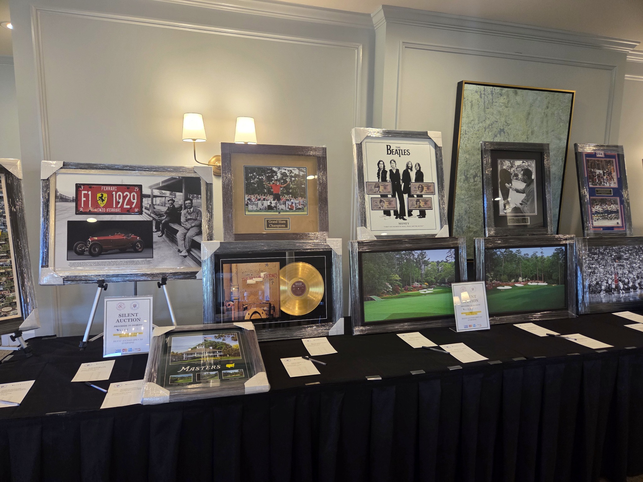 Heritage Sports Gallery auction display featuring Beatles, Rolling Stones, Ferrari, and golf memorabilia