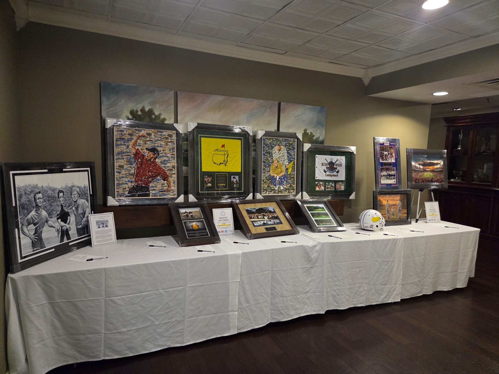 Golf memorabilia arranged across a full silent auction display