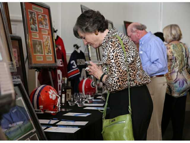 Guests browsing memorabilia and bid sheets at a silent auction